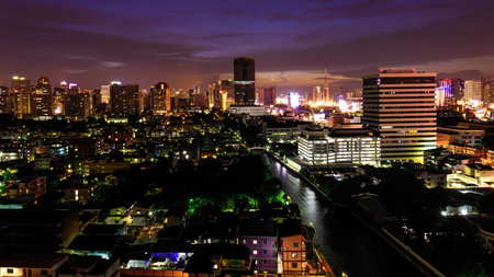 BANGKOK, THAILAND - AUGUST 12, 2017: Aerial view of Modern urban houses and office buildings near Saen Saep canal along Petchburi road in Watthana district at dusk with twilight sky.のeditorial素材