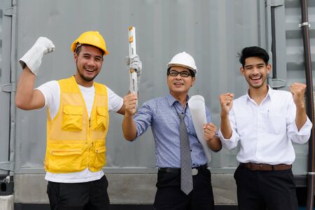 Asian Happy smile Engineering manager, field engineer, foreman celebrate after construction site project complete on time. Business teamwork concept.の写真素材