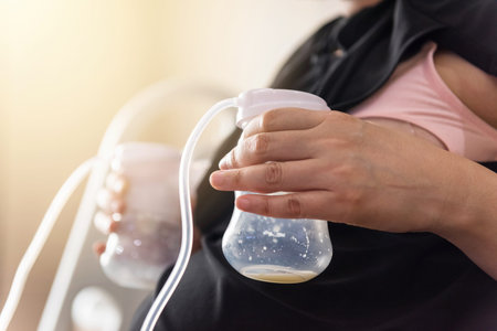 Mother pumped milk from both boobs into Automatic breast pump machine. mom milk is the best healthy...