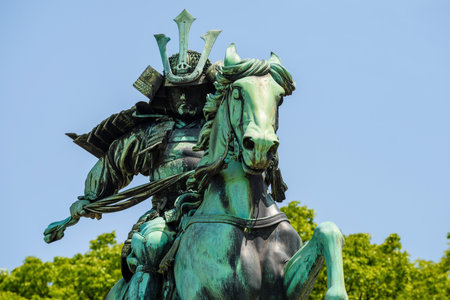 TOKYO, JAPAN - MAY 8, 2017: Closeup front view of the great samurai Kusunoki Masashige and horse monument with clear blue sky. It located at the East Garden outside Tokyo Imperial Palace, Japanのeditorial素材