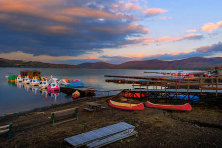 Landscape of Lake Yamanaka with floating recreation boats and twilight sky at dusk, Yamanashi, Japan. Mt Fuji nature travel destinationの写真素材