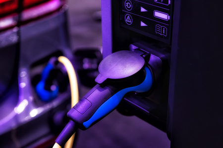 Closeup Power supply for electric car charging station. It plugged into modern vehicle being charged.の写真素材