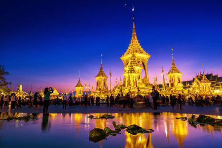 BANGKOK, THAILAND - DECEMBER 22, 2017: Unidentified poeple visit The Royal Cremation of His Majesty ,The Late King Bhumibol Adulyadej, Rama 9, In Remembrance at dusk with twilight sky located at Sanam Luang.のeditorial素材