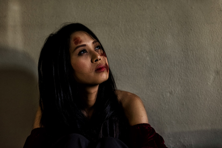 Portrait of pained and sad woman wife with serious violence abuse and attack on her face savaged by her husband. Family  Criminal and Sexual concept. Social issues and problem themeの写真素材