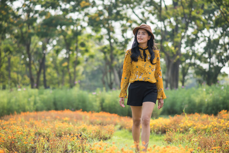 Beautiful young Bohemian Asian girl in boho style outfit and hatの写真素材