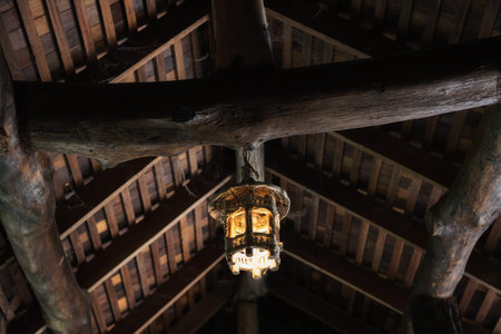 Old wooden lamp hanging on traditional Thai wood roof