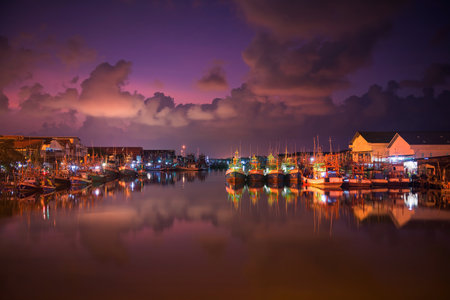Rayong, Thailand - March 05, ,2018: landscape of fishing ships or boats at Pak Nam Rayong River port or dock with twilight sky and river reflection at dawn.のeditorial素材