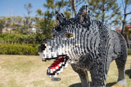 Wolf or dog model decoration in park with copy space for text. statue made by jigsaw puzzle blocks.の写真素材