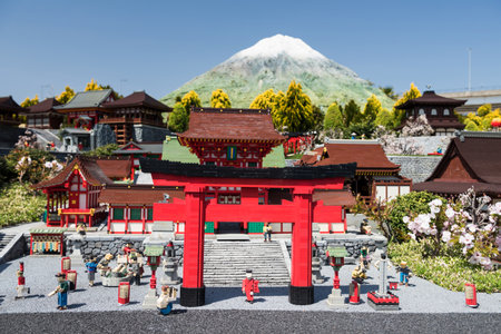 Nagoya, Japan - April 08, 2019: Lego bricks made famous Japanese Kyoto temple, Fushimi Inari Taisha temple with mountain Fuji or Fujisan background in miniature city.のeditorial素材