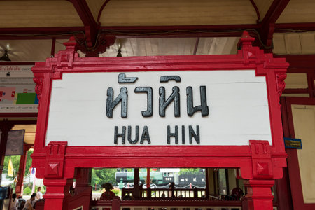 Hua Hin Thailand - August 03, 2019: Hua Hin banner statue in front of train railway station with train and passanger people on platform. Famous travel destination in Prachuap Khiri Khan Province.のeditorial素材