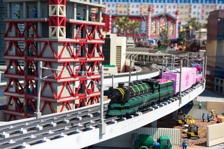 Nagoya, Japan - April 08, 2019: Antique stream train model running on railway with construction site...