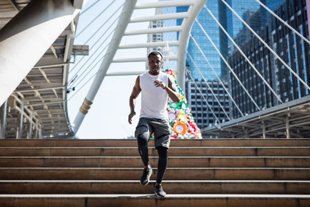 African American young man enjoy jogging and listening online music in urban city with Christmas...