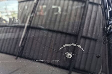 Broke fornt car Windscreen glass by rock of street construction site. Vehicle transportation accident. Need insurance to replace new.の写真素材