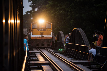 Kanchanaburi, Thailand - October 12, 2019: Tourists on river kwai bridge to see antique train across. Here is famous travel landmark for history of World war2.のeditorial素材
