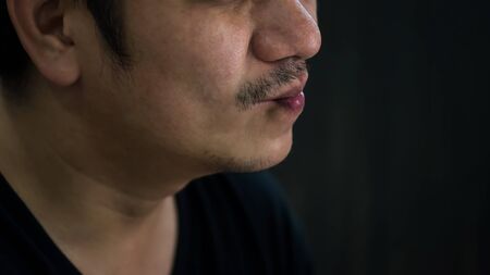 unshaven beard and mustache Asian man pain teeth expression. Stay and work from home during covid-19. New normal, social distancing. toothache due to dental hospital clinic close.の写真素材