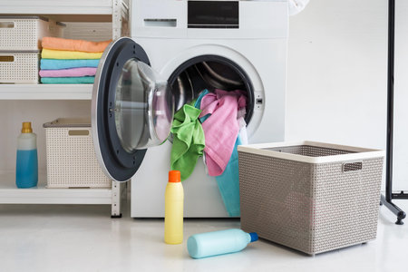 load fabric micro fiber laundry in the washing machine from basket with wash liquid before...