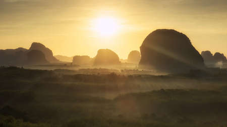 Panorama sunrise landscape at steep mountain ridge and rainforest with mist from Din Daeng (Dang) Doi view point in Krabi province, Thailand. Famous travel destination in Southern of Thai.の写真素材