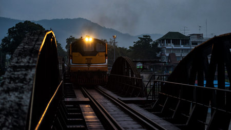 Antique steam train on river Kwai bridge in early morning, Kanchanaburi, Thailand. Famous...