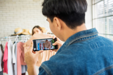 Man live video streaming by smartphone to sell clothes by fashion blogger or Stylist popular...
