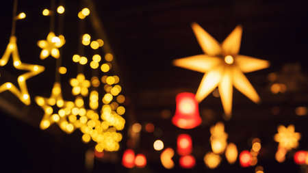 Colorful night lights blurred abstract bokeh star party lights from colorful light bulb in pub and restaurant.の写真素材