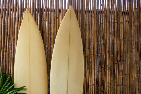 Two surfboard on bamboo wooden wall. Extreme outdoor sport activity for summer holiday vacation  at...