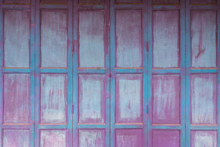 Old purple and blue wooden door or wall. Wood pattern background. Ancient exterior decorationの写真素材