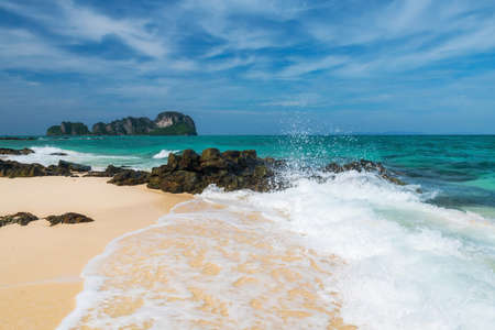 Motion wave hit stone arch with turquoise andaman sea and blue sky at Bamboo island or Koh Mai Phai, Krabi, Thailand. Famous travel destination or holiday maker of Siam. Andaman seascape.の写真素材