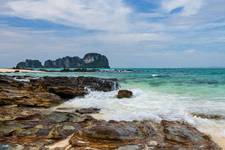 Seascape of motion wave hit stone arch with turquoise andaman sea and blue sky at Bamboo island or Koh Mai Phai, Krabi, Thailand. Famous travel destination or summer holiday maker of Siam.の写真素材