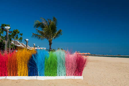 Colorful fake grass decorated on sand beach against blue sky at Cha-Am, Phetchaburi, Thailand.の写真素材
