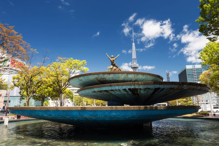 Nake woman statue on fountain of TV tower at Odori park against blue sky in spring, Nagoya, Japan. Sakae district landmarkのeditorial素材