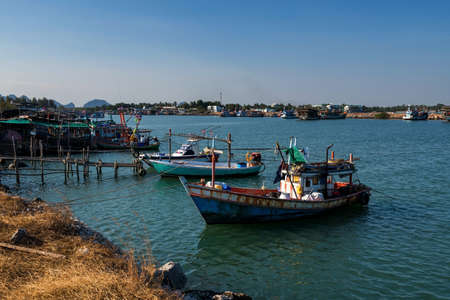 Fishing boats at fisherman dock in sea against blue sky at Cha Am, Phetchaburi, Thailand. Seafood industry.の写真素材