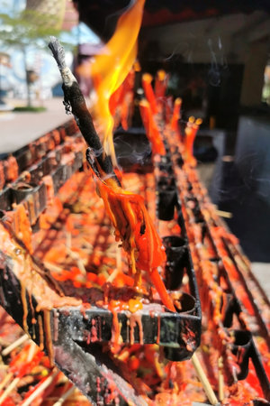 Red big joss stick with fire in chinese temple, Suphan Buri, Thailand. Burning Praying Stickの写真素材