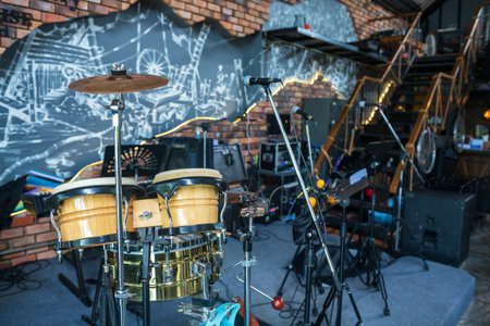 drum kit with microphone and electric instruments placed on a stage ready for a performance concert at restaurantの写真素材