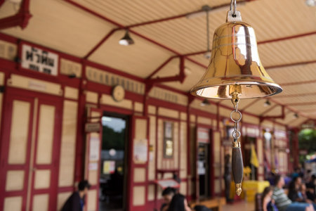 Golden bell with blurred tourist people at Hua Hin train station banner in Prachuap Khiri Khan...