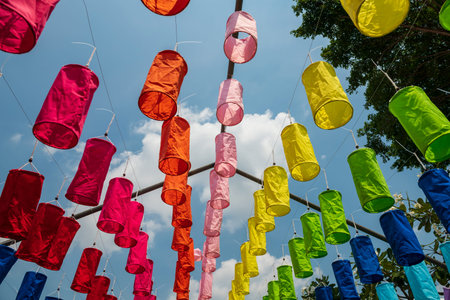 Colorful fabric lamp hanging agaisnt blue sky for garden decoration.の写真素材