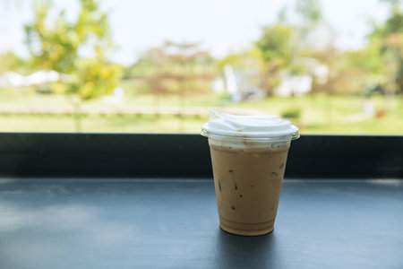 Iced cappuccino coffee on plastic glass at outdoor restaurant and cafe. Food and drink industryの写真素材