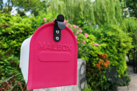 old vintage mail box at garden surrounded by green treeの写真素材