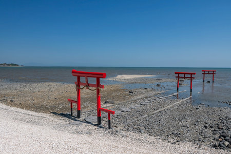 Landscape of 3 red torii gates against blue sky at Oouo Shrine by Ariake sea in Tara Town, Saga, Kyushu, Japan. Famous travel destination. Japanese language Okino means offshore or open sea in Englishの写真素材