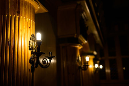 Antique lamp on wall column at night decorate inside hotel. Vintage interior decoration.の写真素材
