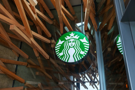 Fukuoka, Japan - Mar 30, 2024: iconic Starbucks coffee banner logo in front of store in Dazaifu, design by Kengo Kuma, famous Japanese architect.のeditorial素材
