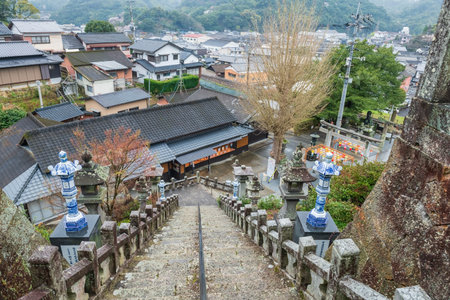 Imari, Japan - Mar 31, 2024: Aerial view of porcelain pillar by uphill footpath of Tozan Sueyama shinto shrine with Imari town, Saga, Japan. Famous travel destination for its ceramic art in spring.のeditorial素材