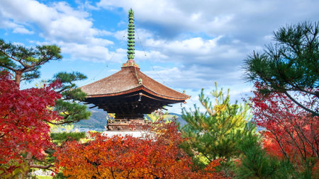 Wooden pagoda roof with colorful fall foliage leaves garden at Jojakkoji Temple, Arashiyama, Kyoto,...