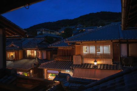 Restaurant, souvenir shop, and houses along Ninenzaka street at night in the historic district of Kyoto, Japan. A well-preserved traditional neighborhood showing illuminated buildings with characteristic architecture.の写真素材