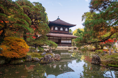Silver Pavilion of Ginkakuji temple with skyline reflection on pond and autumn foliage color, Kyoto,...