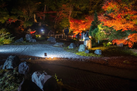 Rock garden with colorful maple leaves light up of Kurodani Konkai Komyoji temple park illumination, Kyoto, Japan. Famous travel destination for tourist sightseeing Kansai for fall illusion.の写真素材