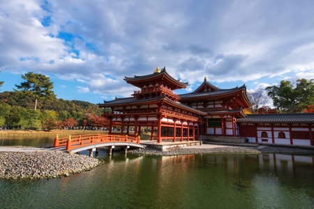 Phoenix Hall of Byodo-In or Byodoin temple Unesco World Heritage Site with colorful maple leaves in autumn, Uji, Kyoto, Japan. Famous travel destination for tourist in Kansai on peak fall in December.の写真素材