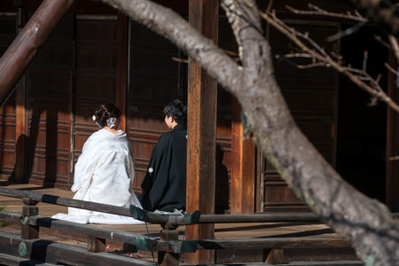 Japanese couple in traditional wedding dress photo shoot at Bishamondo temple in autumn, Kyoto, Japan. Famous travel destination for tourist in Kansai on peak fall in December.の写真素材