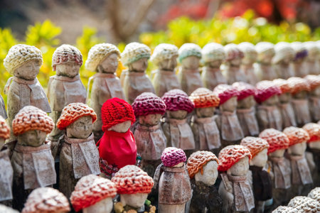 Many Jizu statues in colorful knit hats decor at autumn garden of Hase-dera or Hasedera Temple, Sakurai, Nara, Japan. travel destination for tourist in Kansai on peak fall in December.の写真素材