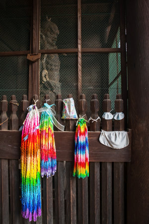 Colorful Origami art, folding piece of paper, to sacred Guardian statue of Hasedera Buddhist temple, Nara, Japan. Famous travel destination for tourist in Kansai on peak fall in December.の写真素材