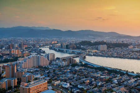 sunset cityscape view of curve expressway through city view from Fukuoka tower at dusk golden hour, Kyushu, Japan. Famous travel destination to see downtown landscape by bay.の写真素材